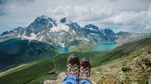 Low section of man and woman against mountains