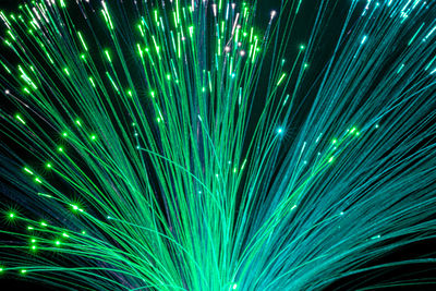 Optical fiber network cable on dark background.