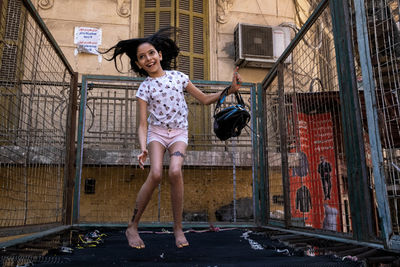 Woman standing against building in city