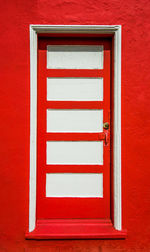 Red closed door of building