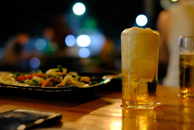 Close-up of beer glass on table