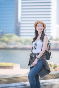Portrait of smiling young woman standing outdoors