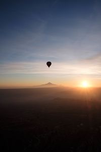 Hot air balloons against sky during sunset