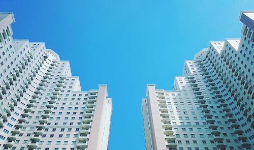 Low angle view of buildings against clear blue sky