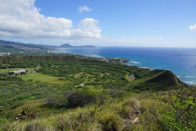 Scenic view of sea and mountains against sky