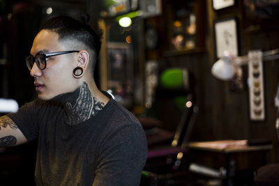 Young man sitting in workshop