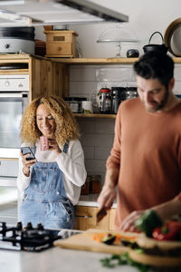 Midsection of woman holding food at home