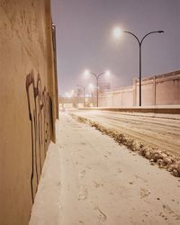 Illuminated street light against clear sky at night