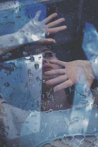 Midsection of woman holding wet glass