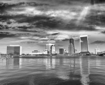 City by river against sky