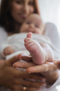 Health insurance for newborn babies. life insurance for new baby. mother holding in hands feet of