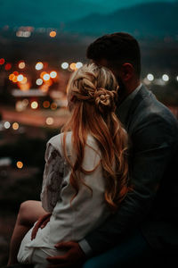 Midsection of woman standing at illuminated night