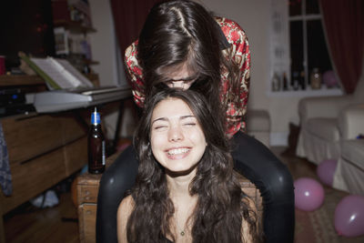 Portrait of a smiling young woman at home