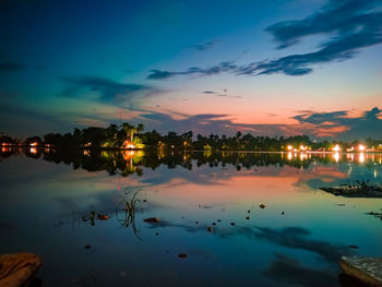 Scenic view of lake against sky at sunset