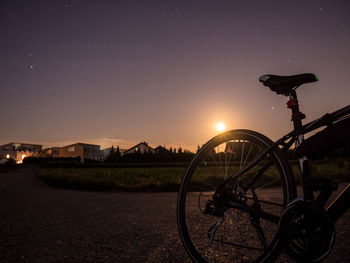 Bicycle against sky at night