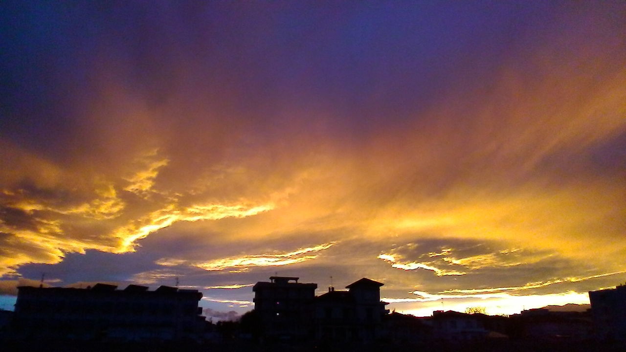 CITY AGAINST CLOUDY SKY DURING SUNSET