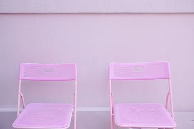 Empty chairs against wall