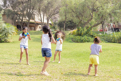 Siblings playing in lawn