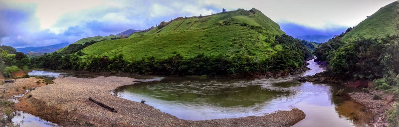 Panoramic view of river amidst trees against sky