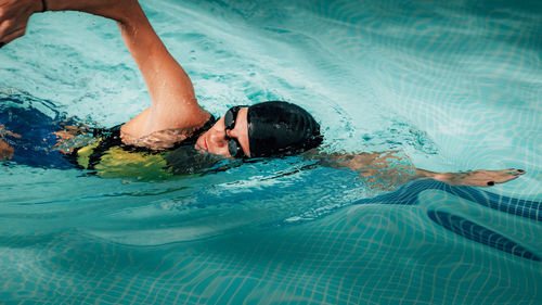 High angle view of woman swimming in pool