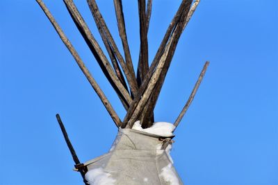 Low angle view of sculpture against clear blue sky
