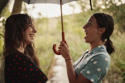 Close-up of smiling friends outdoors