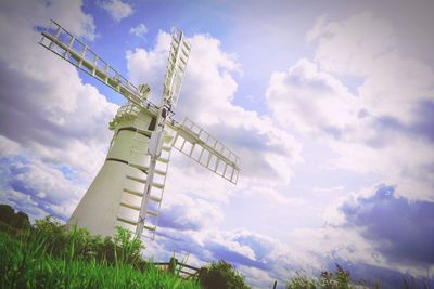 Low angle view of windmill against cloudy sky