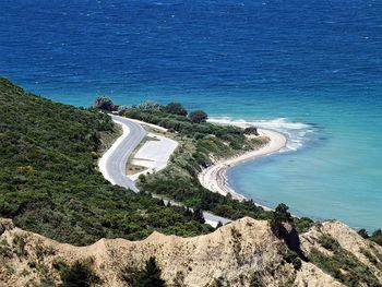 High angle view of trees by sea