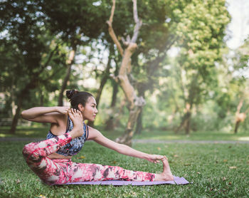 Full length of woman practicing yoga at park