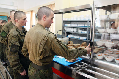 Side view of man standing in store