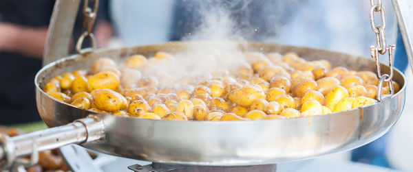 Close-up of potatoes boiling in cooking pan