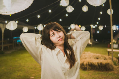 Portrait of young woman standing outdoors