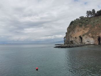 Scenic view of sea against cloudy sky