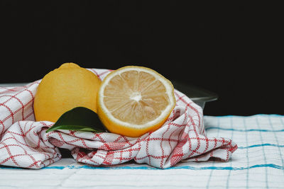 Close-up of fruits on table against black background