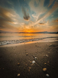 Scenic view of beach against sky during sunset