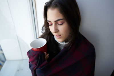 Close-up of woman having coffee at home