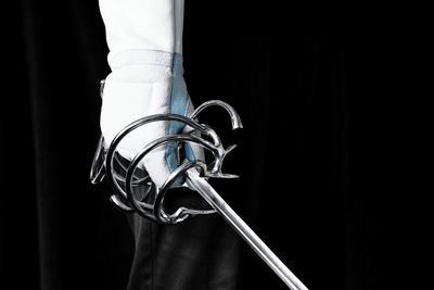 Cropped hand holding sword