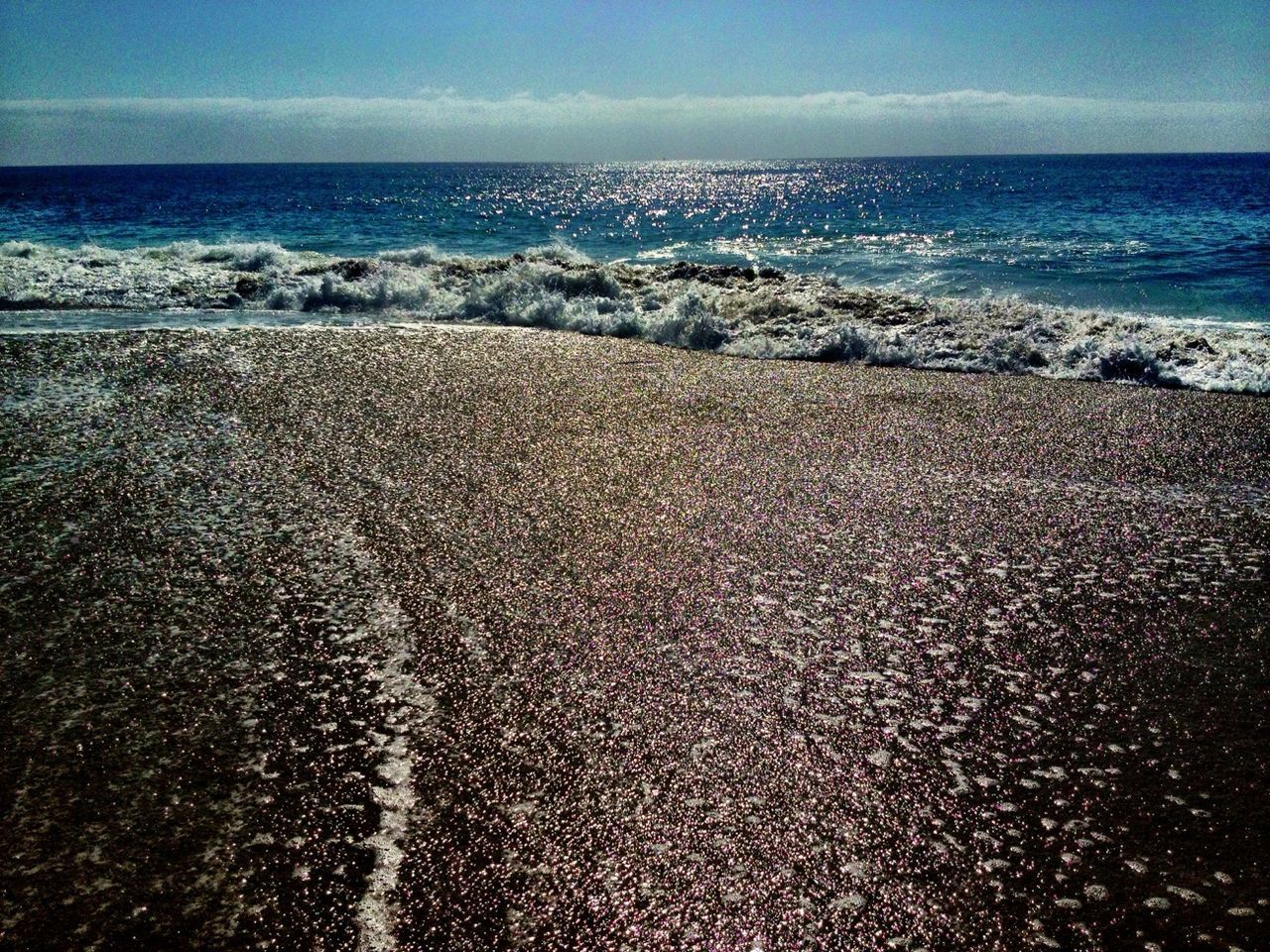 sea, horizon over water, water, beach, shore, tranquil scene, scenics, tranquility, beauty in nature, sand, nature, wave, sky, coastline, idyllic, surf, seascape, clear sky, remote, blue