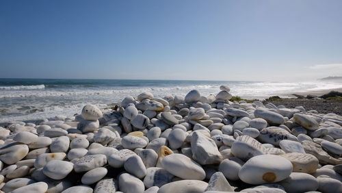 Rocks on beach against sky