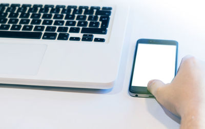 Close-up of hand using laptop