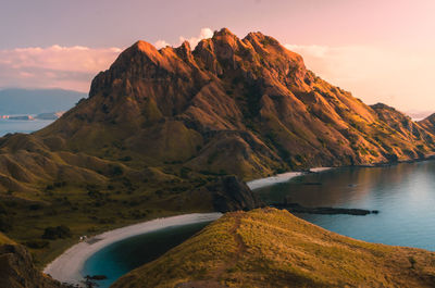 Scenic view of sea and mountains against sky during sunset