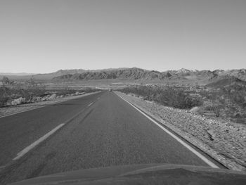 Empty road leading towards mountains