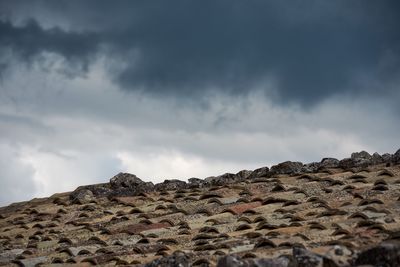 Low angle view of rocks against sky