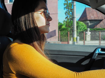 Portrait of young woman in car