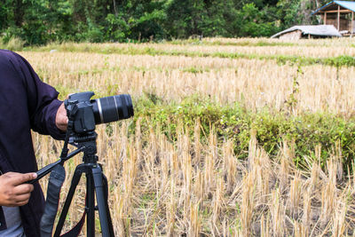 Man photographing on field