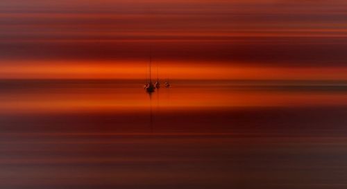 Scenic view of sea at sunset