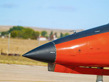 Close-up of airplane wing against sky