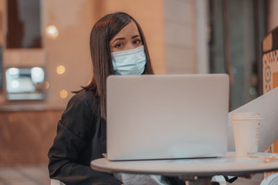 Young woman using laptop on table