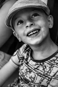 Close-up of happy boy wearing flat cap while looking away