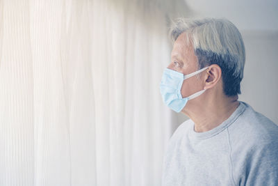 Portrait of man wearing hat against wall